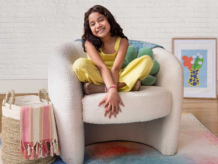 image of little girl smiling while sitting on couch